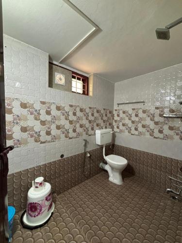 a bathroom with a toilet in a room at Homestay INN in Anachal