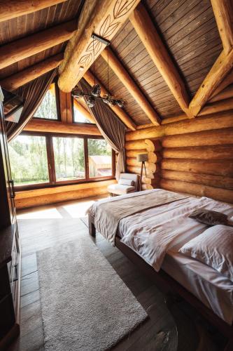 a bedroom with a bed in a log cabin at Casa Di Giorgio in Borsa