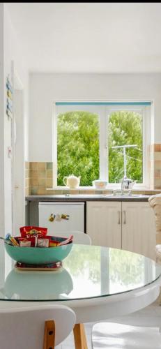 a kitchen with a glass table with a bowl on it at Lorna's Apartment Self Catering Holiday Home in Milltown Malbay