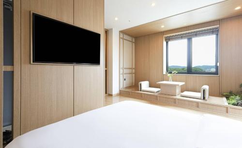 a large room with a flat screen tv on a wall at ALMOND Hotel in Jinju