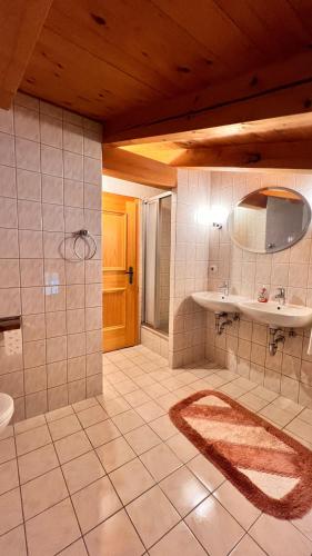 a large bathroom with a sink and a toilet at Gästehaus Binderlehen in Schönau am Königssee