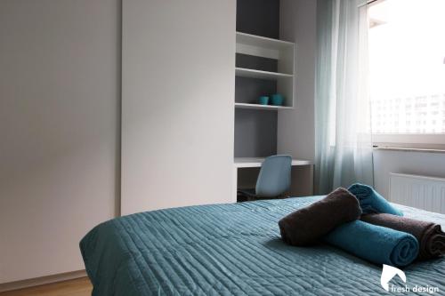 a bedroom with a bed with towels on it at Apartament nad Odrą in Wrocław