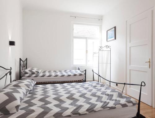 a bedroom with two beds in front of a window at Star Apartment Zagreb in Zagreb