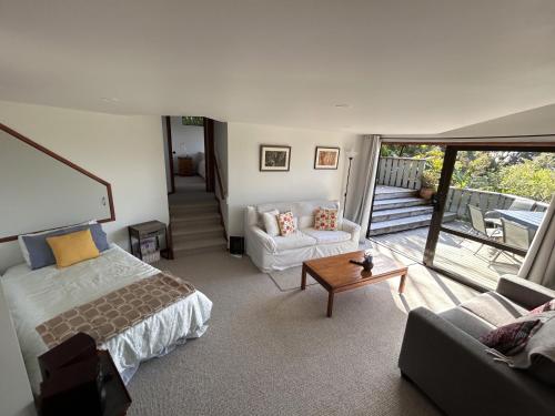 a bedroom with a bed and a living room at Palm Heights in Palm Beach