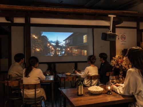a group of people sitting at a table in a restaurant at Yuimaru EAST - 最大18名貸切OK in Kanazawa