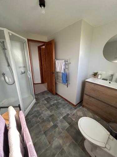 a bathroom with a toilet and a sink and a shower at Palm Heights in Palm Beach