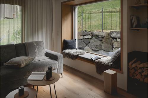 a living room with a couch and a window at Lieblingsplatz Alpine Lodge in Tschagguns