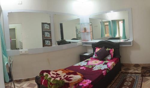 a room with a bed and a mirror at Krishnabalram wellness & Ayurveda centre in Rishīkesh
