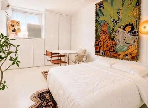 a bedroom with a bed and a painting on the wall at TOV stay in Seoul
