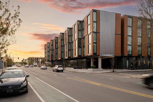 a building on the side of a street with cars at Cambria Hotel Boston Somerville in Somerville