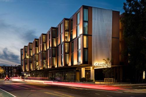 a building on the side of a street at night at Cambria Hotel Boston Somerville in Somerville