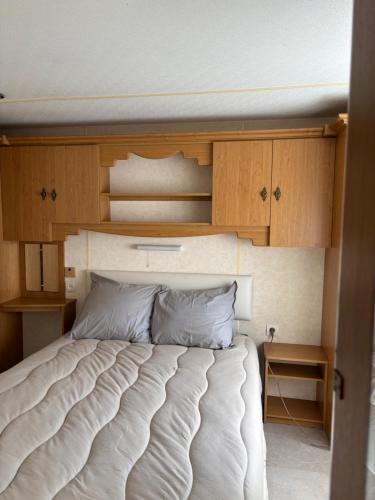 a bedroom with a large bed with wooden cabinets at Zeester 91 in Scherpenisse