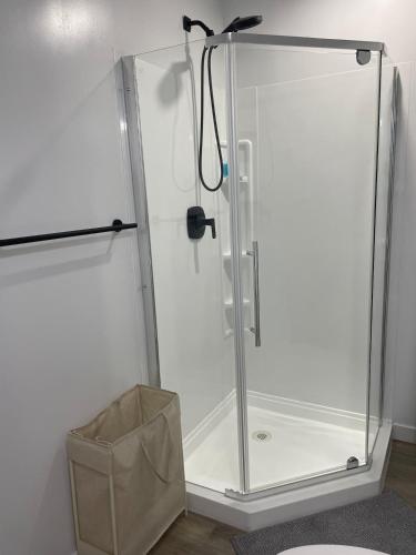 a shower with a glass door in a bathroom at Lakeview 2Bedroom Walkout Suite with Trail View in Winnipeg