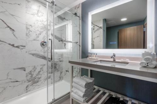 a bathroom with a sink and a shower at Cambria Hotel West Orange in West Orange
