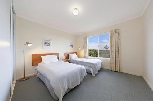 a hotel room with two beds and a window at Tahren Beach Getaway in Middleton