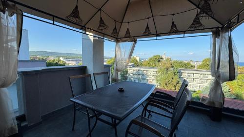 a dining room with a table and chairs on a balcony at Studio Precious in Kranevo