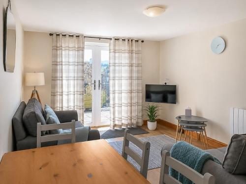 a living room with a couch and a table at Howgills Apartment 8 - Ukc9727 in Sedbergh