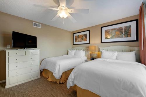 a bedroom with two beds and a flat screen tv at Bluegreen Vacations Orlando's Sunshine, Ascend Collection Resort in Orlando