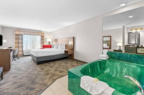 a hotel room with a tub and a bed at Country Inn & Suites by Radisson Kenosha - Pleasant Prairie in Kenosha