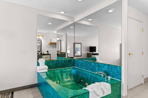 a bathroom with a turquoise tub at Country Inn & Suites by Radisson Kenosha - Pleasant Prairie in Kenosha