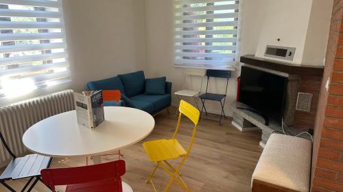 a living room with a couch and a table and chairs at A lì dai Nûtis in Venzone