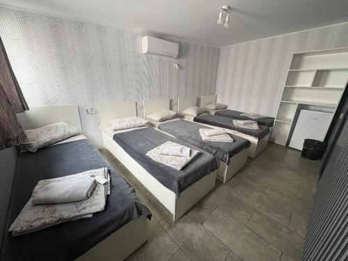 a room with four beds in a row in a room at Amalya in Constanţa