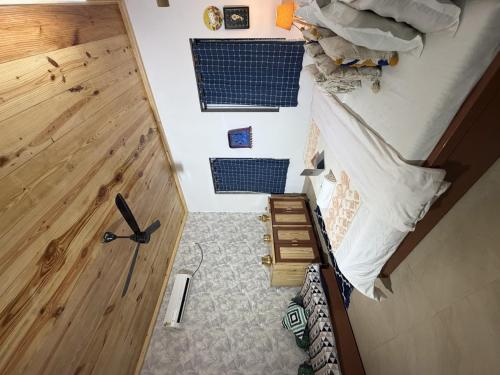 a room with a bed and a wooden door at SeaBreeze in Bārsiv