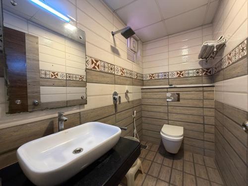 a bathroom with a sink and a toilet at Hotel Sai Krish Grand Pallavaram in Chennai