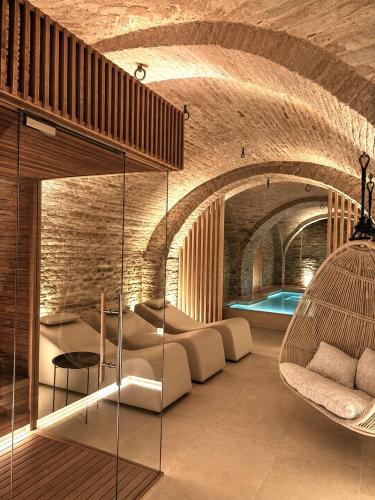 a living room with a couch and a chair at Palazzo Cortesi Boutique Hotel in Macerata