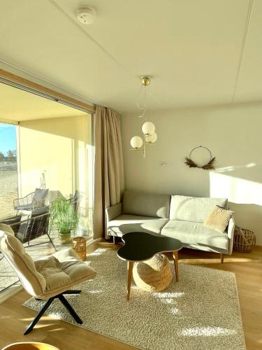 a living room with a couch and a table at Marina Sunset Resort A2 in Kalajoki