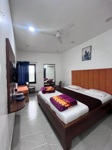a bedroom with a large bed in a room at Jalsa hotel in Raipura