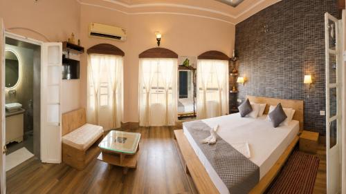 a bedroom with a bed and a brick wall at Shiva Ganges View Guest House in Varanasi