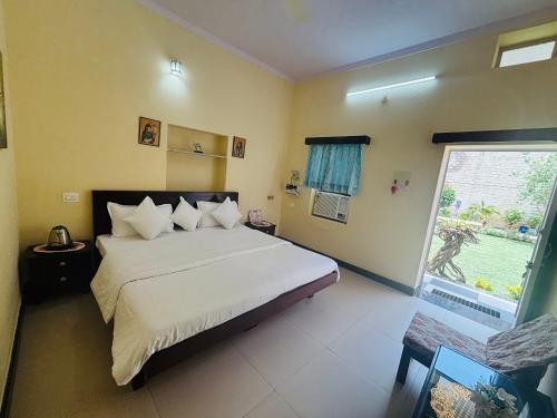 a bedroom with a large bed and a window at Liliyan Palace Guest house in Jodhpur