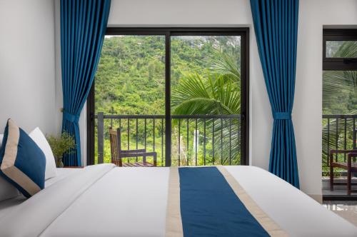 a bedroom with a bed and a large window at CATBA HEVEN HILLs in Xuan Dam
