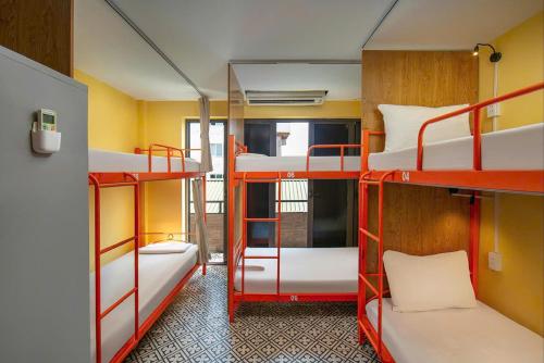 a room with three bunk beds in a room at Downtown Hostel HANOI & HA GIANG LOOP TOUR OFFICE in Hanoi