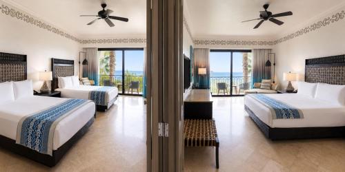 a hotel room with two beds and a balcony at Hilton Los Cabos in San José del Cabo