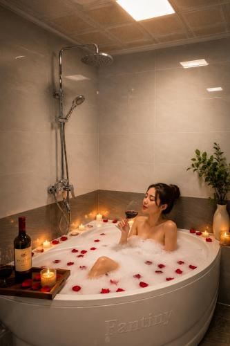 a man in a bath tub filled with roses at Lavender SaPa Hotel & Spa Right in the center of Sa Pa - Free foot soak service in Lao Cai