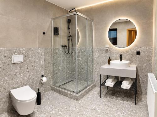 a bathroom with a shower and a toilet and a sink at Villa Johannes in Warmensteinach