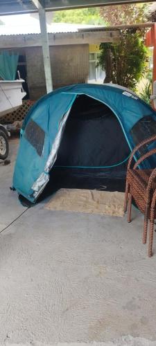 a blue tent on the ground with a chair at Banian Camping petit déjeuner offert in Bora Bora