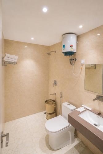 a bathroom with a toilet and a sink at Hotel 33 Inn in Kānpur