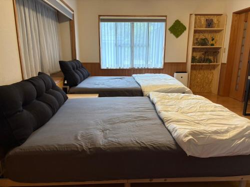 a living room with two beds and a couch at Anan Seaside House in Anan