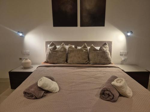 a bedroom with a large bed with towels on it at Modern Designer Apartment Private Yard in Hamrun
