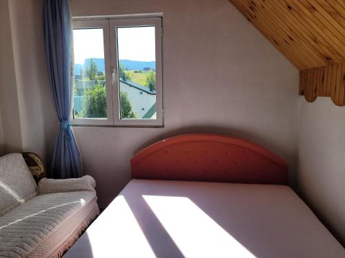 a small room with a couch and a window at Guesthouse Mijatovic in Žabljak