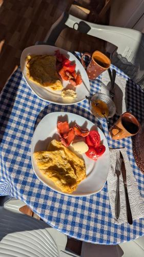 two plates of food on a blue and white table at Guests house, Artani in Valbonë