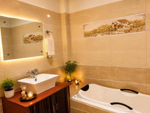 a bathroom with a sink and a bath tub at Shiva Ganges View Guest House in Varanasi