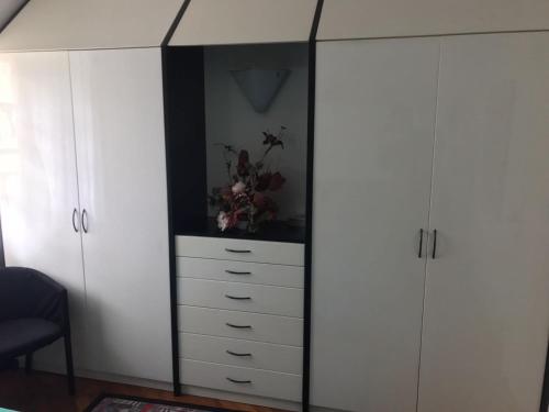 a large white cabinet with a mirror in a room at Appartamento Bernasconi in Madesimo
