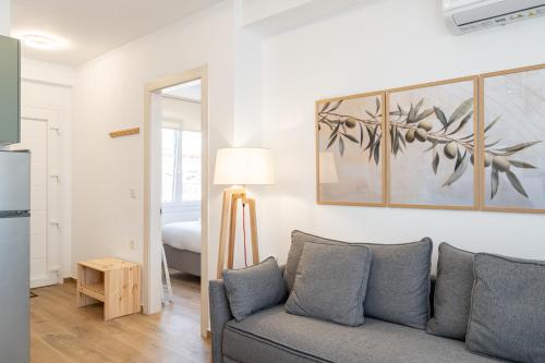 a living room with a couch and a bed at Green Almond Residential Complex in Orfánion