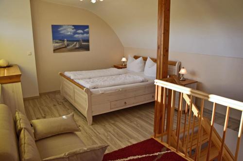 a bedroom with a bed and a staircase in it at Bella Casa 36 - Mones in Juliusruh
