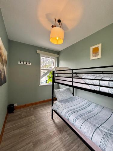 a bedroom with two bunk beds and a window at Strandhill Guesthouse in Sligo