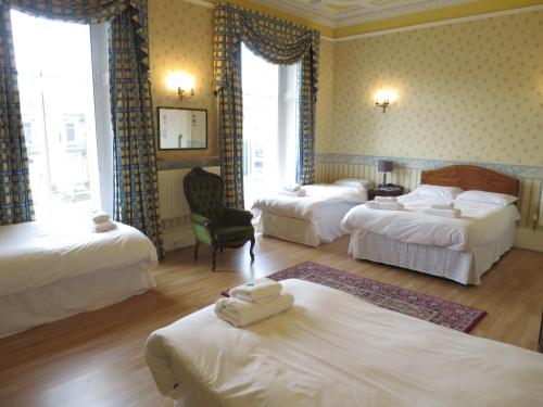 a hotel room with two beds and two lamps at Thornfield Guest Residence in Edinburgh